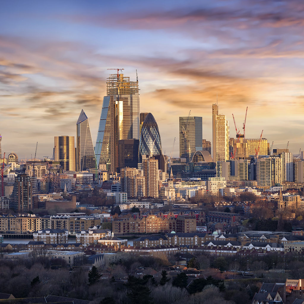 Sunrise over the urban skyline of the City of London, UK, financial district and hub of banking institutions