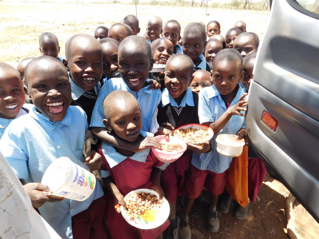 Photo of young children in Burkina Faso, Africa being provided with food